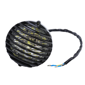 Grille de protection métallique noire posée sur un phare rond de moto rétro - vue 7