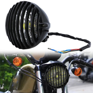 Grille de protection métallique noire posée sur un phare rond de moto rétro - vue 1