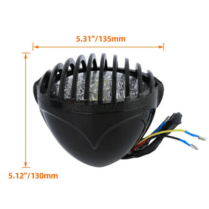 Grille de protection métallique noire posée sur un phare rond de moto rétro - vue 5